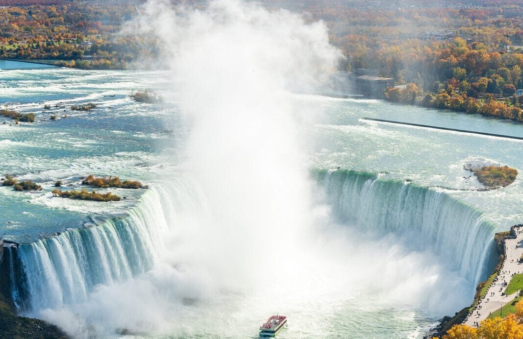 Overlooking the Niagara Falls Horseshoe Falls in a sunny day in autumn foliage season. Niagara Falls City