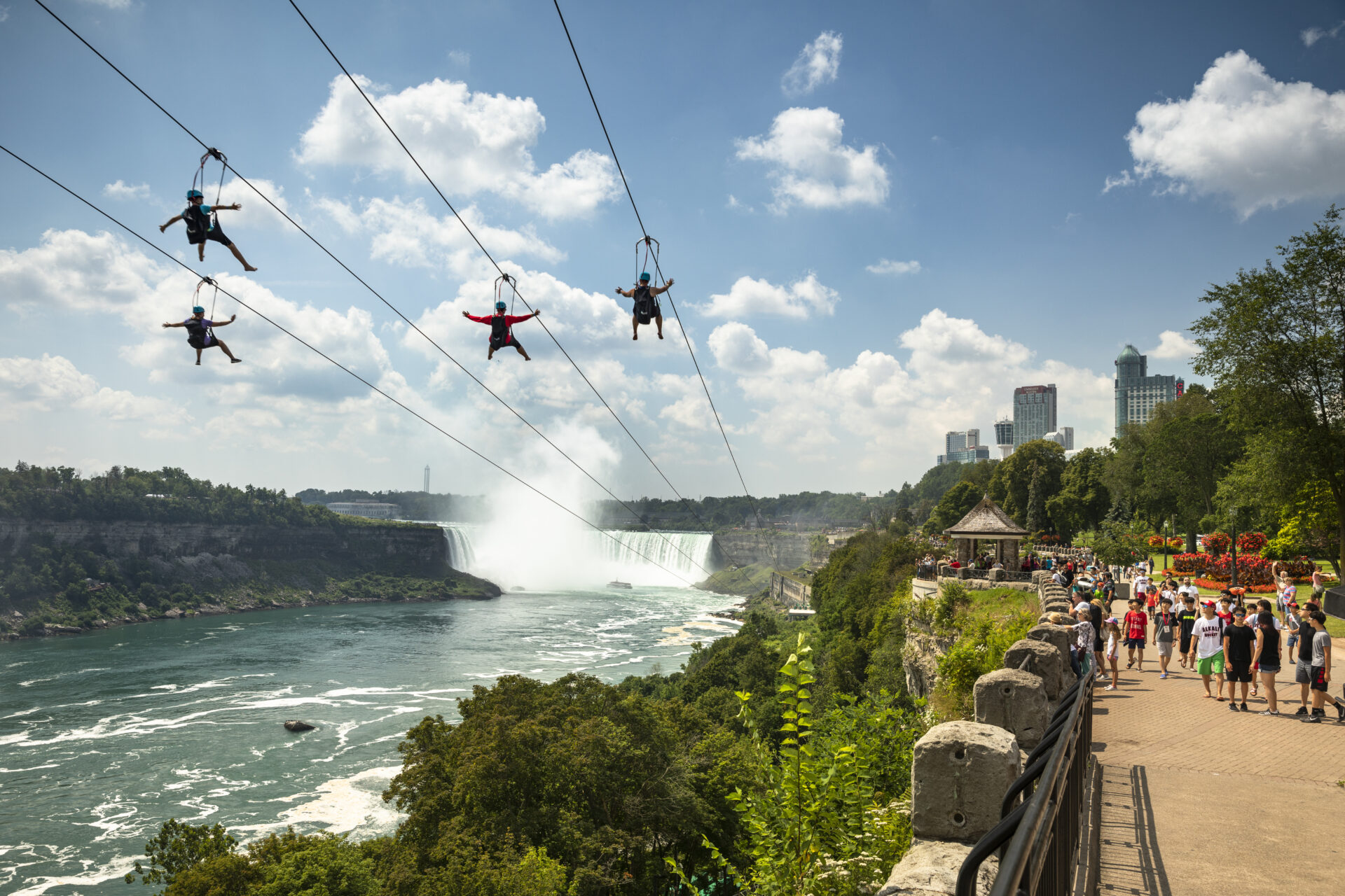 Tourists Zipline over Niagara Falls by the Horsehoe Falls